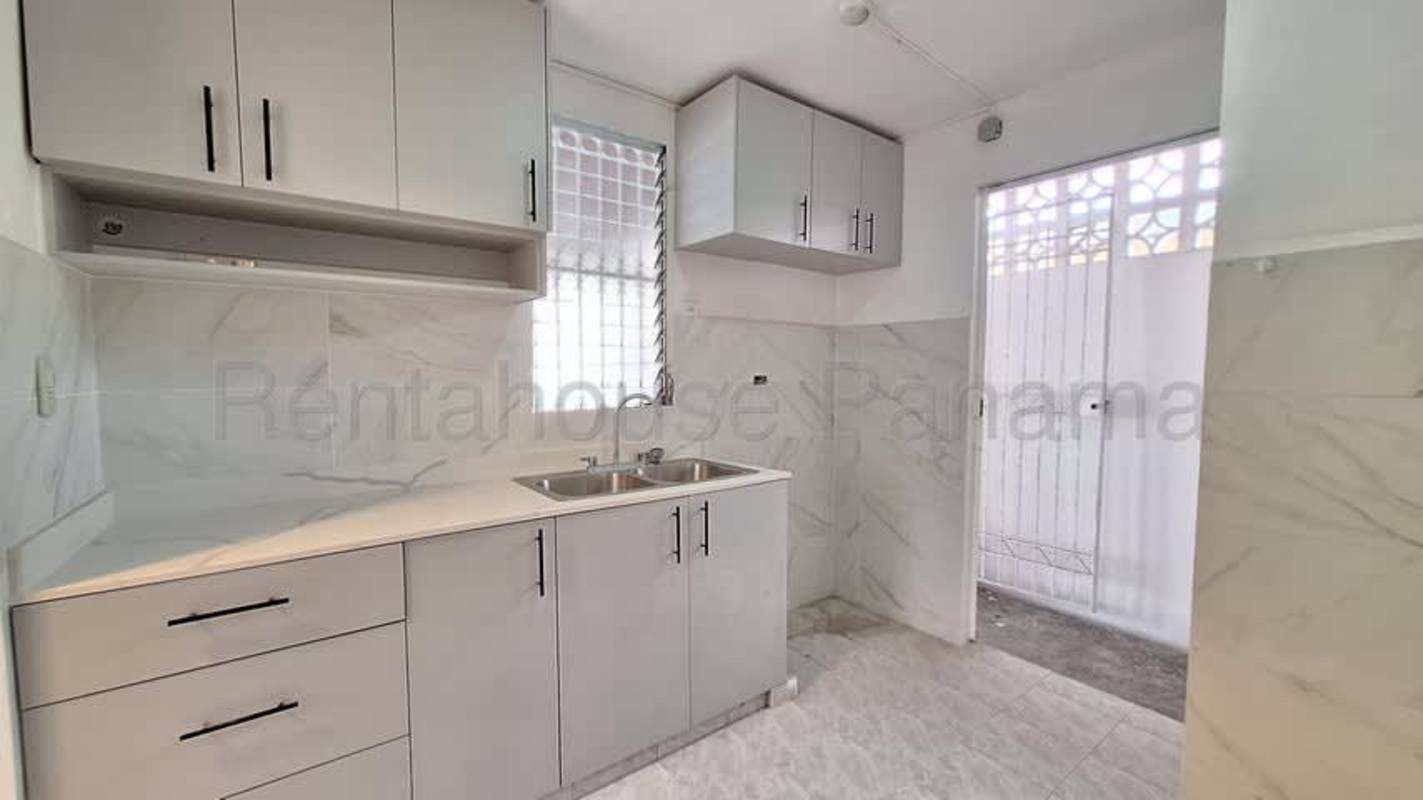 Living room area with ceramic floor, arched windows, glass door and recessed lights