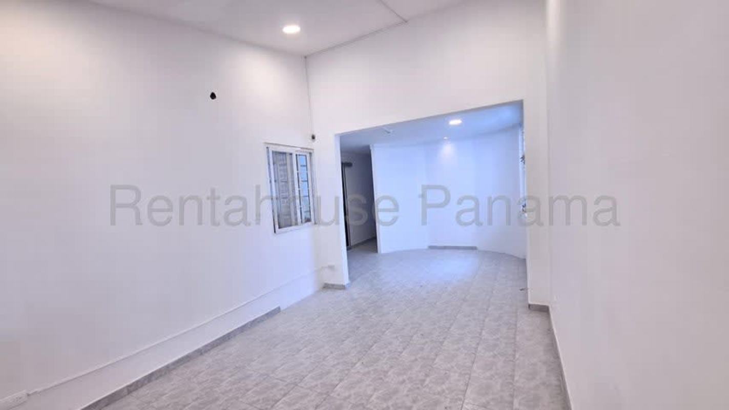 Bright empty bedroom with closet, barred window, tiled floor in Panama City
