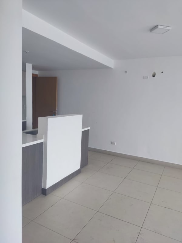 Modern minimalist kitchen with white cabinets granite countertops and open layout in PH Scala El Carmen Panama