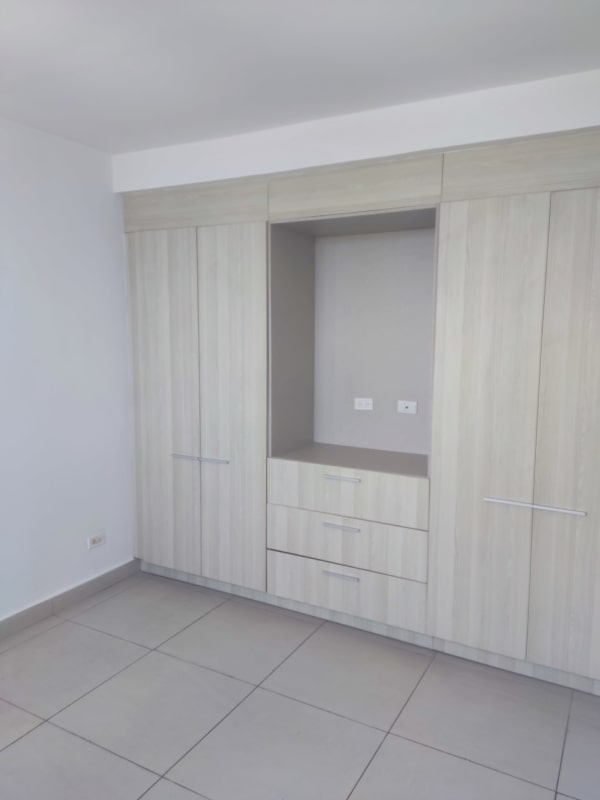 Bedroom with built-in light wood wardrobe tile floor neutral wall PH Scala El Carmen Panama