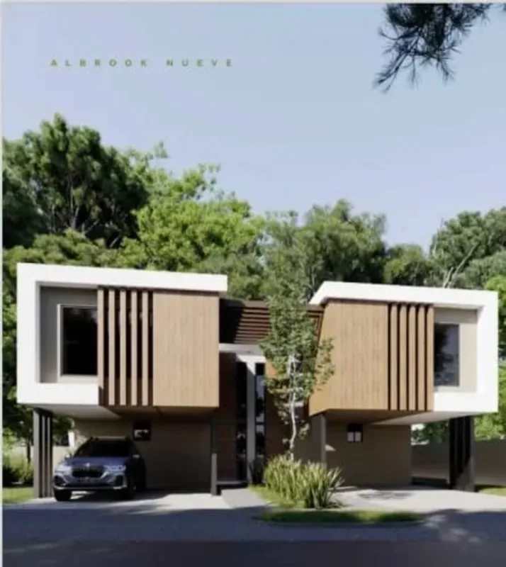 Modern duplex facade of new house with large windows wood accents in Albrook Panama