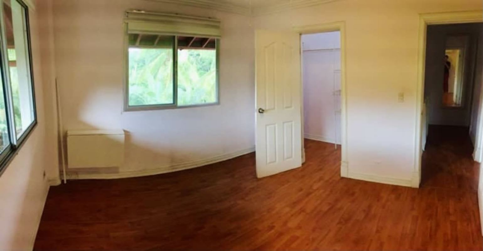 Bedroom large windows wood flooring tranquil neighborhood in duplex Albrook Clayton Panama