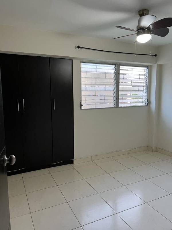 Bedroom with tile flooring, closet, ceiling fan, window in apartment near universities San Miguelito Panama