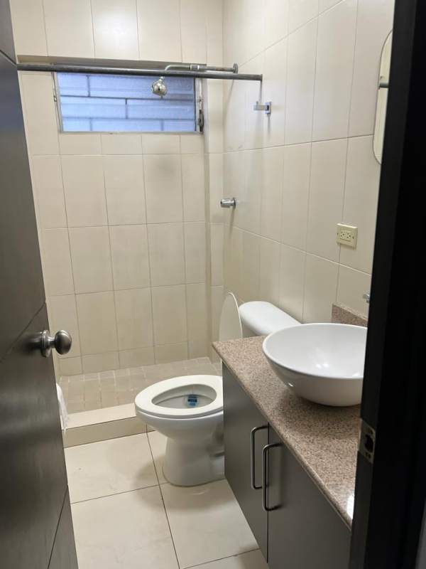 Bedroom with dark wardrobe, ceiling fan, louver windows for apartment rental San Miguelito Panama