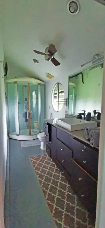 Spacious modern bathroom with double vanity sinks, glass shower, natural light, Albrook Panama