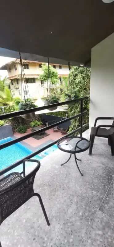 Covered balcony with seating and glass rail, pool view luxury house Albrook Panama