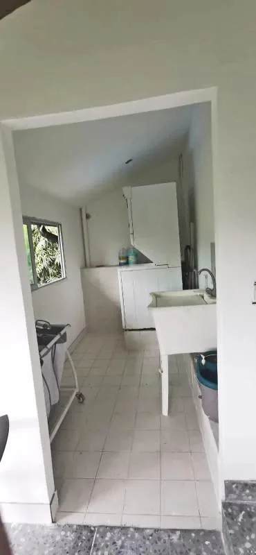 Laundry room with white tile, cabinetry, sink in luxury house Albrook Panama