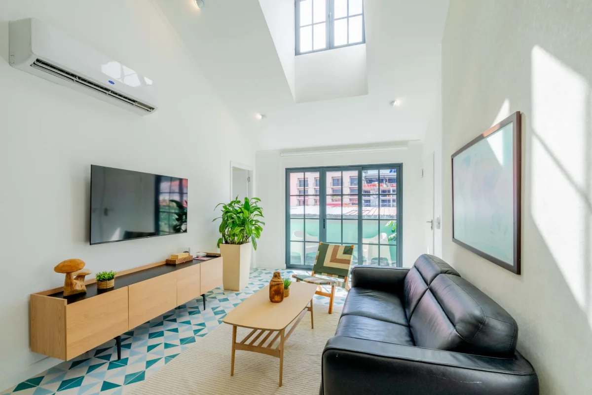 Bright living area with access to Juliet balcony and city views in Casco Viejo apartment Panama