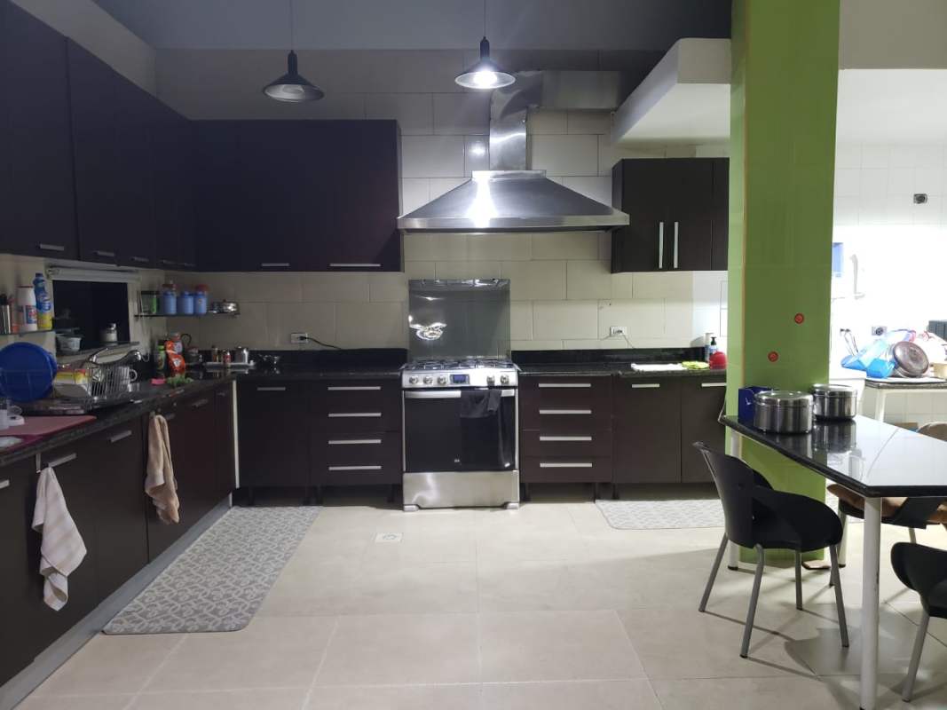 Gated community street lined with Mediterranean style two-story houses, PH Altos del Country, Panama