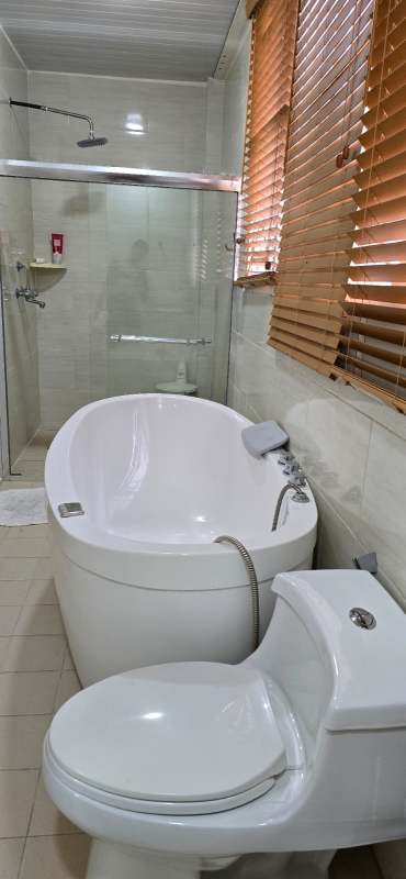 Luxury bathroom featuring freestanding tub and glass shower enclosure in PH Altos del Country 3000 Panama