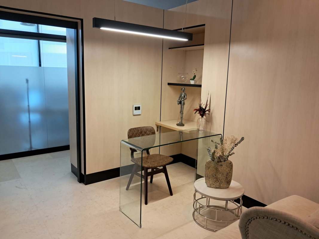 Small workspace nook with glass desk and decor Edison Corporate Center Panama