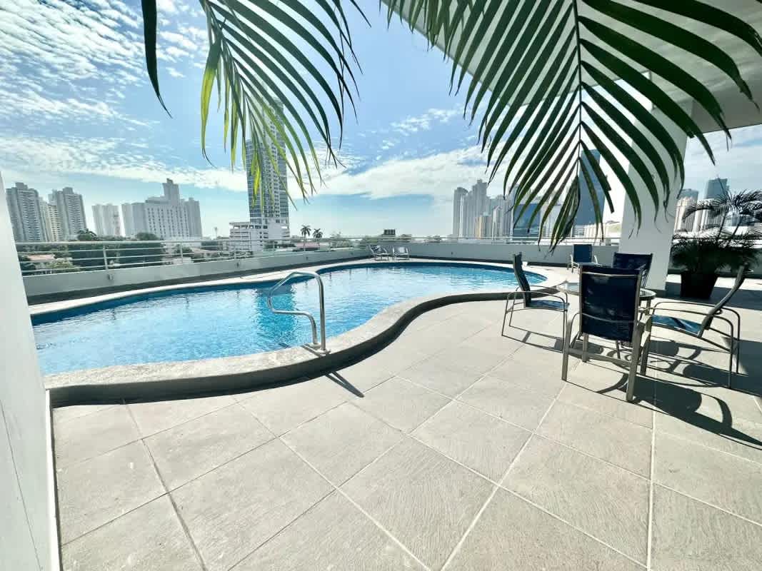 Contemporary kitchen featuring granite countertops and skyline window view at PH Terrazas del Pacífico Panama City