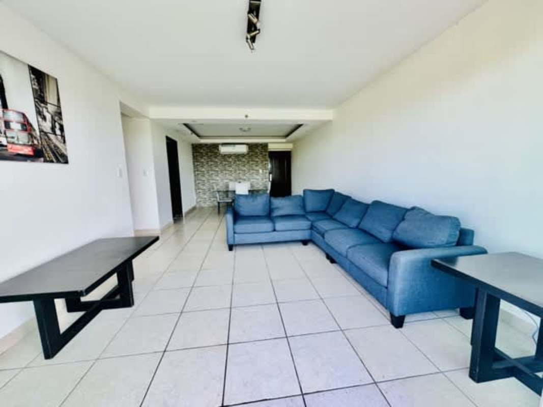 Modern living room with blue sectional sofa, tiled floors, AC, in PH Clayton Park Clayton Panama