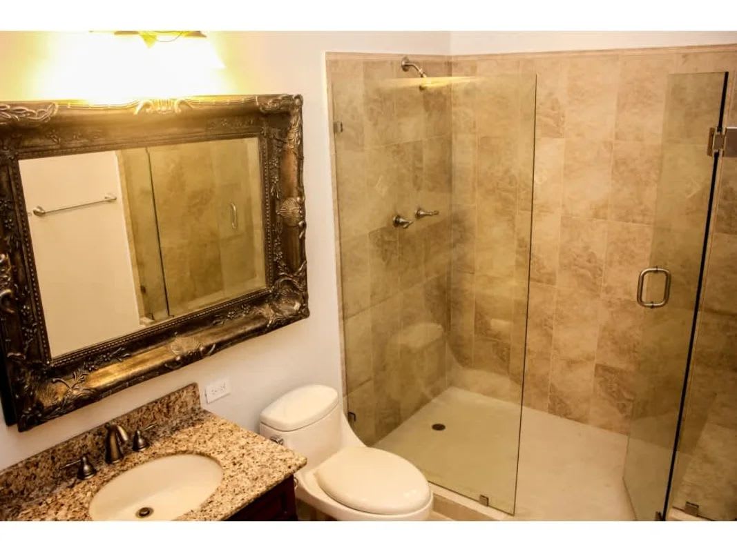 Bright living room with high cedar ceilings, large window, ceiling fan in house for rent Panama Cardenas