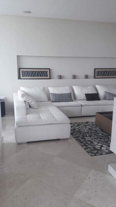 Modern living room with floor-to-ceiling windows and ocean view at The Point Punta Paitilla Panama