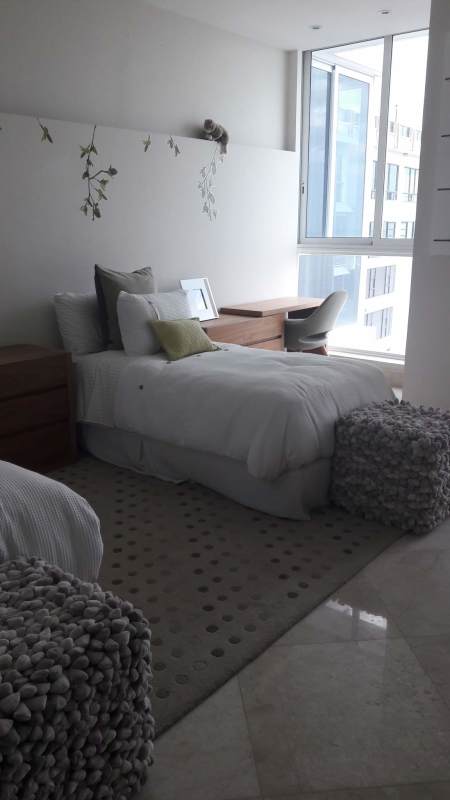 Modern twin bedroom with large windows and neutral decor at The Point Punta Paitilla Panama