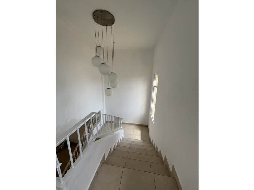 Interior staircase with pendant lamps and white rails PH Villa Tiloli Panama