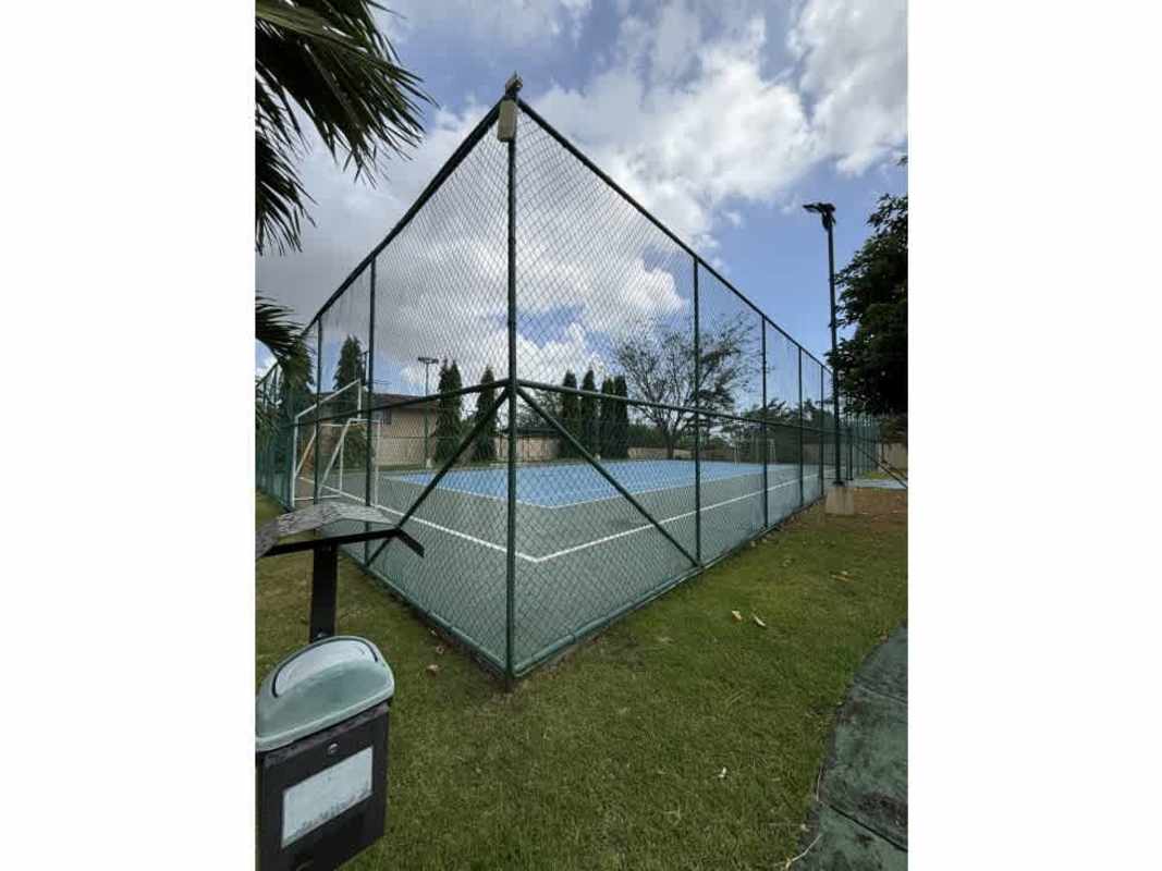 Outdoor fenced tennis courts at PH Villa Tiloli with grass surrounding Panama