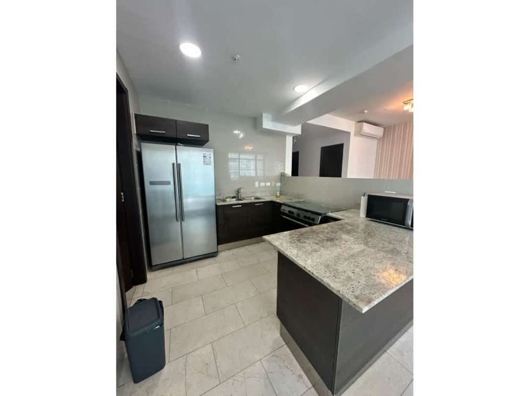 Furnished living and dining room with floor-to-ceiling windows and stunning ocean views in Grand Tower Punta Pacífica Panama City