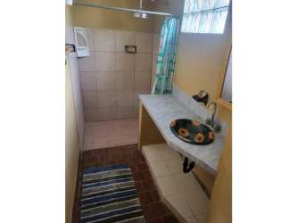 Bathroom with walk-in shower, artistic sink, glass block window, Panama Coronado rental