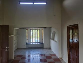 Spacious living area with rustic beams, tiled floors and large windows in Coronado beach house Panama