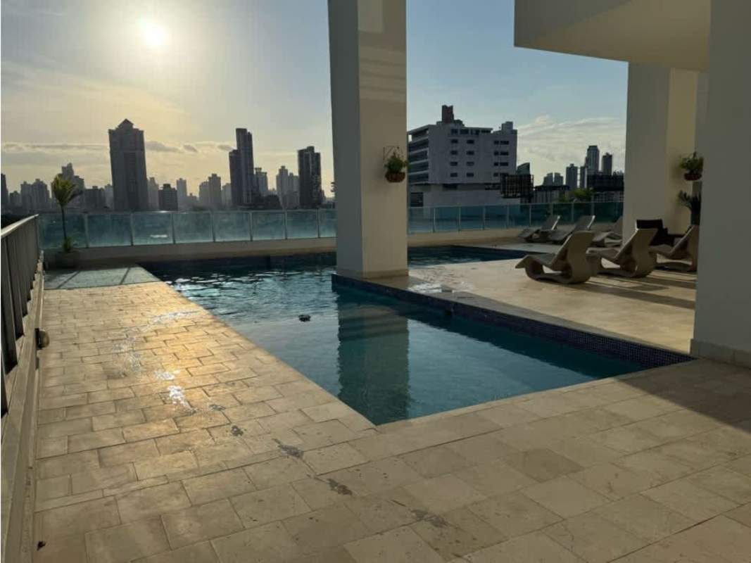 Bathroom with glass enclosed shower, double vessel sinks, mosaic tile detail and wood-look flooring at PH Joy Tower Panama City