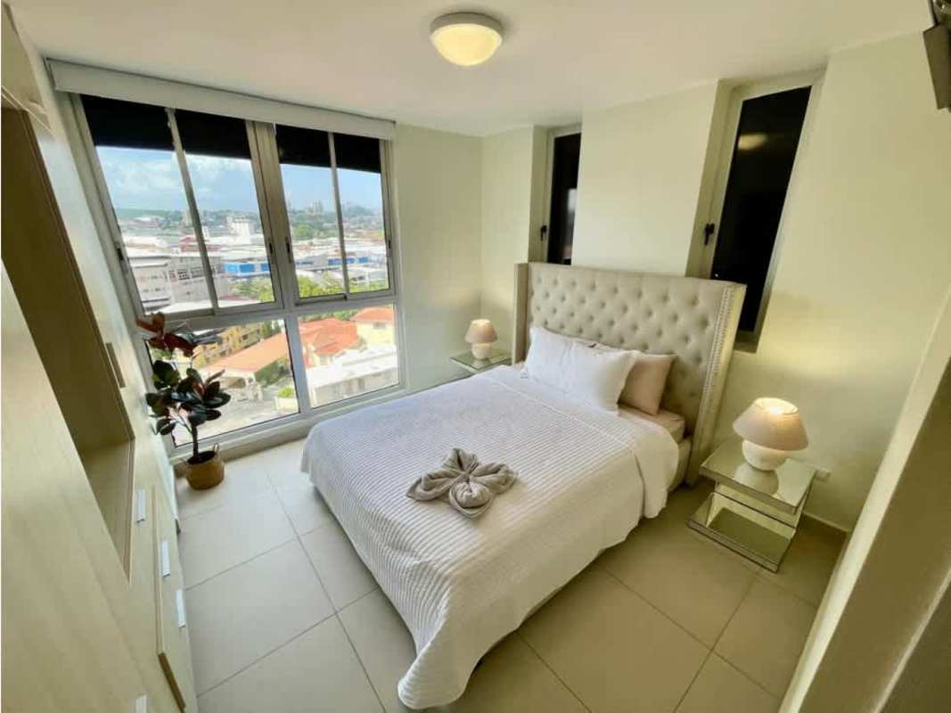 Modern bedroom with large window and city skyline view PH Scala El Carmen Panama