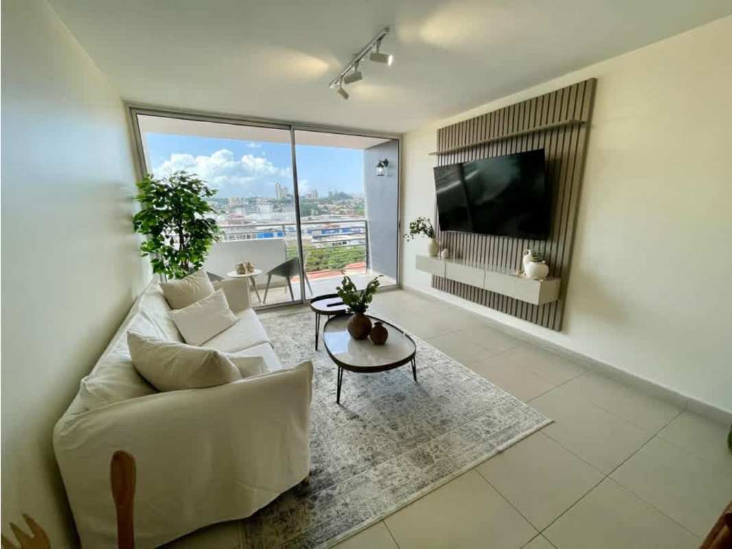 Modern open-concept living space with large window and balcony city view PH Scala Panama