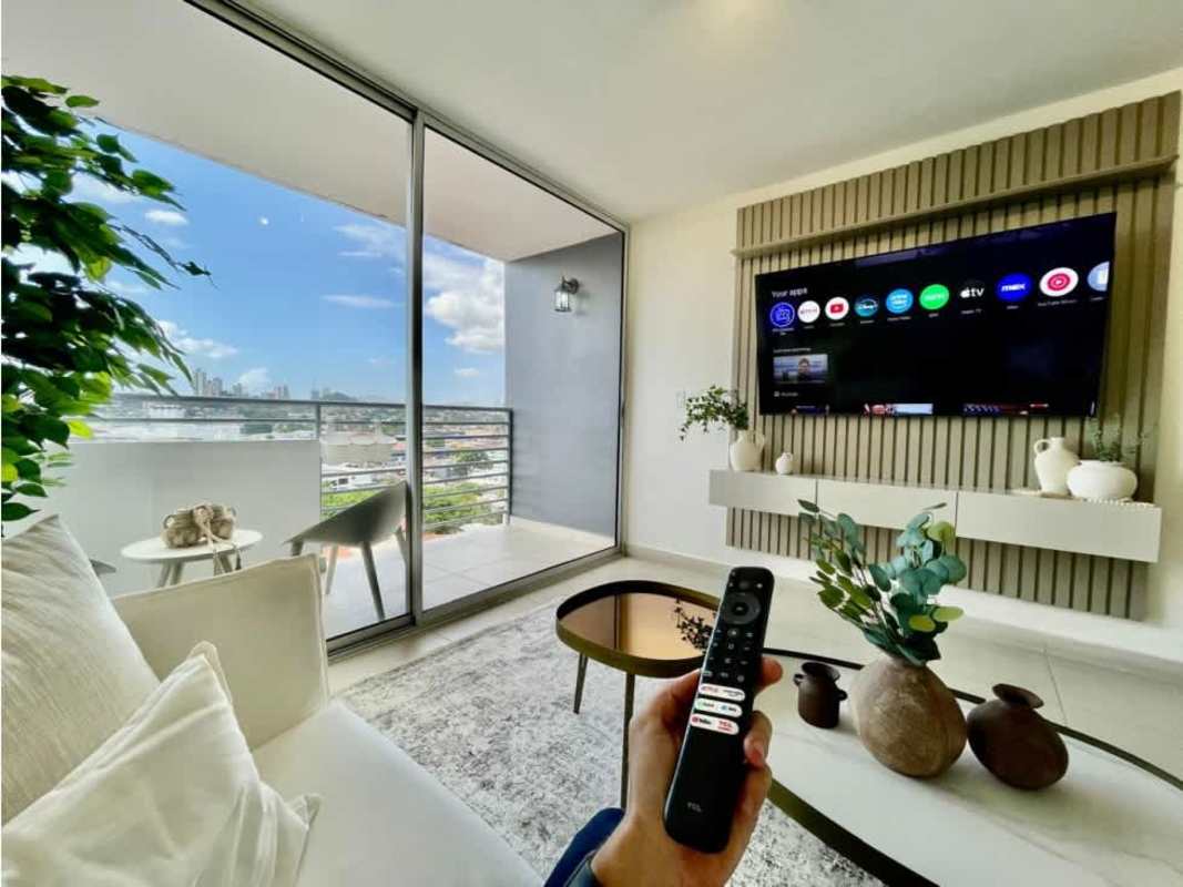 Bright living room with sliding doors leading to balcony with city view in PH Scala El Carmen Panama City