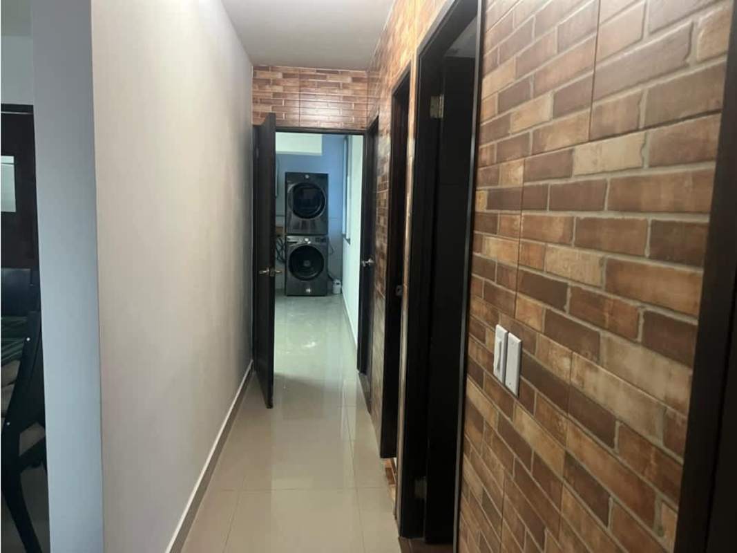 Hallway view with laundry stacked washer dryer at Titanium Tower Panama