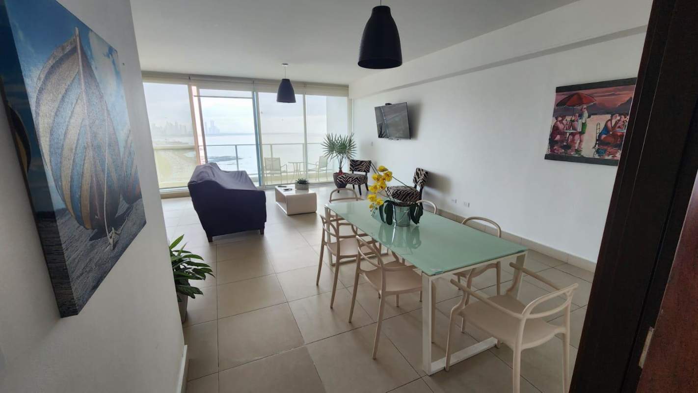 Spacious living room with modern décor, ocean view balcony and floor-to-ceiling windows in PH Oceanaire