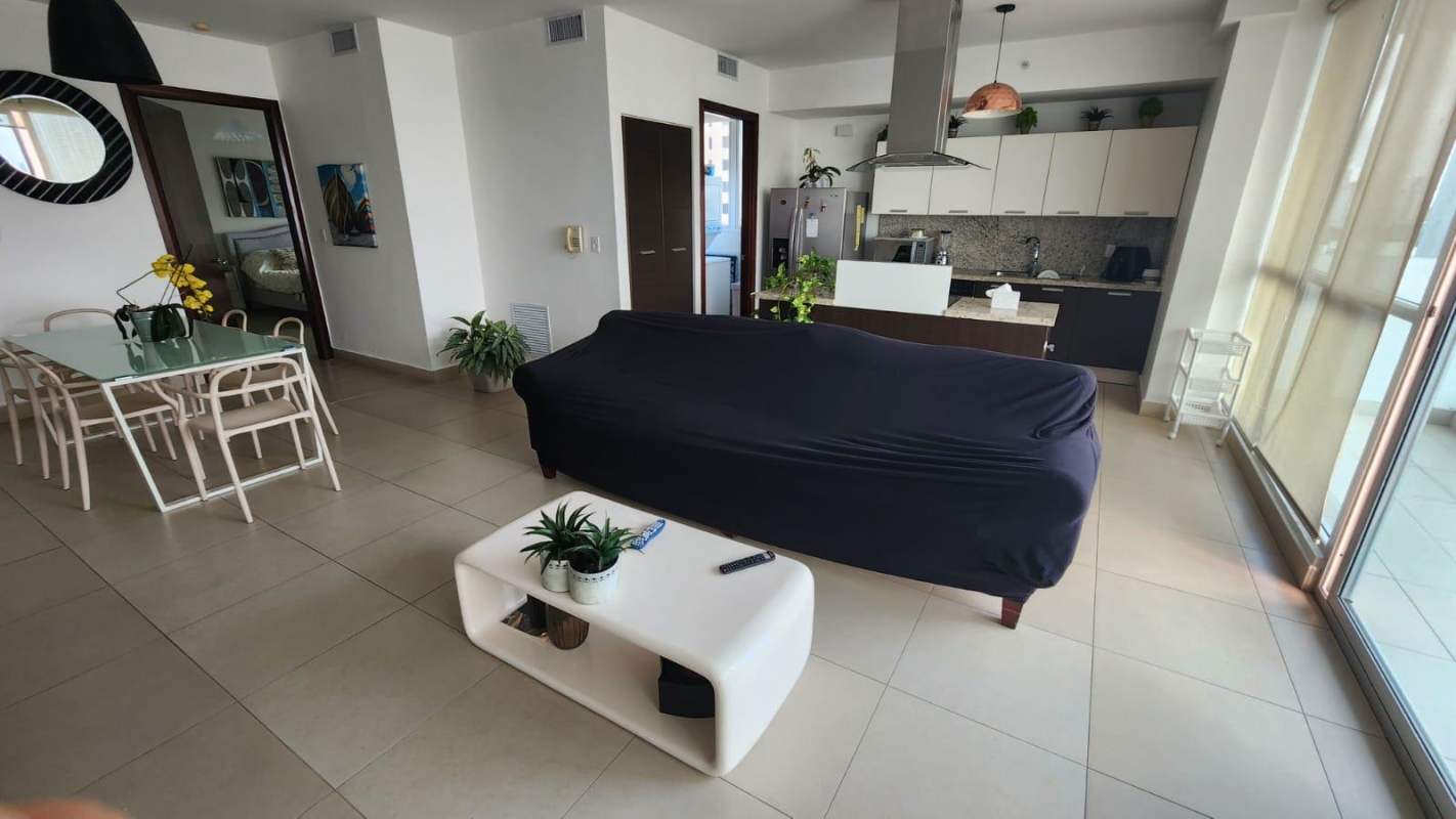 Modern open-plan living dining area with balcony access and oceanfront views in Punta Pacífica