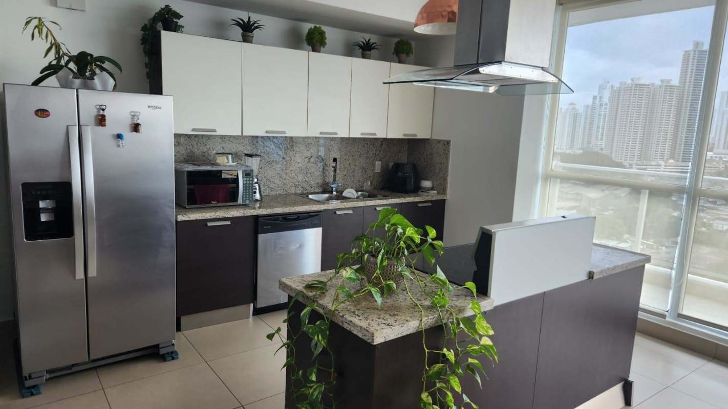 Contemporary kitchen with granite countertops, appliances, and large window city views in PH Oceanaire Punta Pacífica