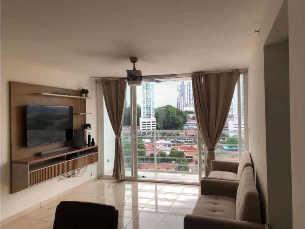 Furnished living room with large windows, sofa, entertainment center ceiling fan, PH Sabana Tower Panama