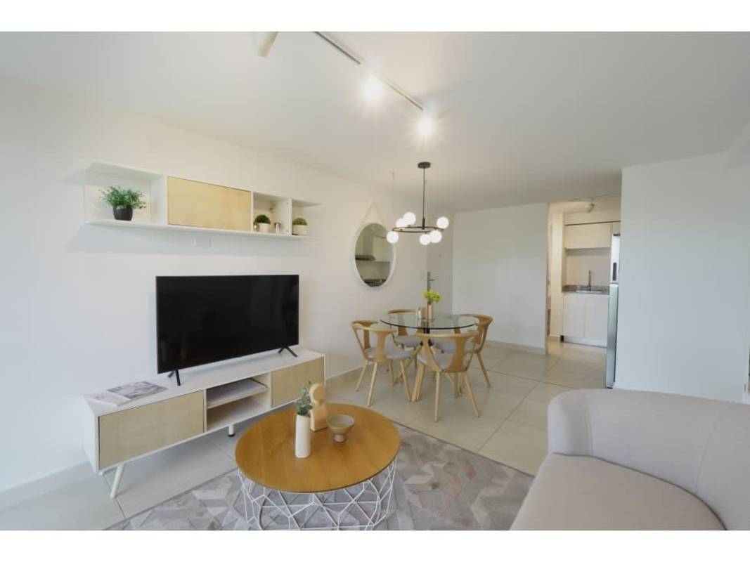 Apartment kitchen with white cabinetry and granite countertop at Panama Viejo Residences Panama