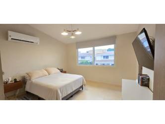 Large outdoor swimming pool with lounge area in Bosques del Pacífico gated community Panamá Pacifico