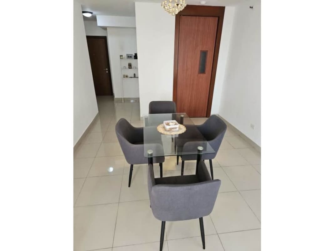 Contemporary dining space with glass dining table and accent lighting in PH Residencias del Sol Panama