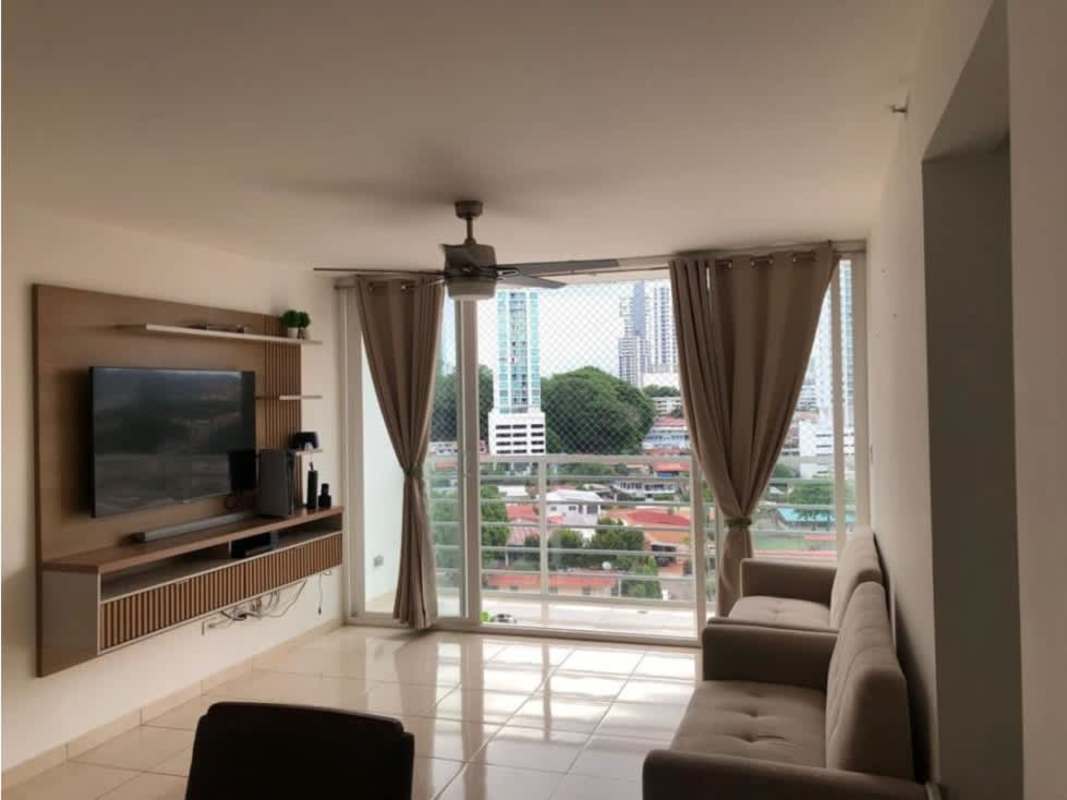 Modern living room with large windows, city view, and entertainment setup at PH Sabana Tower Panama