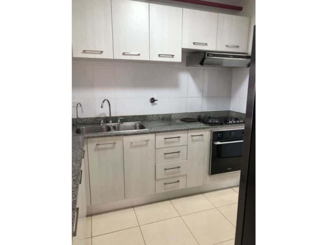 Kitchen with granite countertops stove oven and storage cabinets in PH Sabana Tower apartment