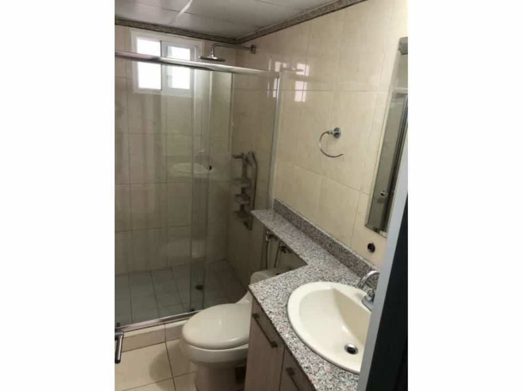 Modern bathroom with enclosed shower and granite sink counter at PH Sabana Tower apartment