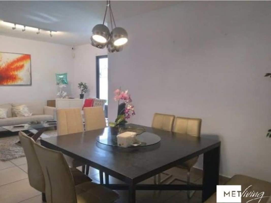 Spacious open living and dining room with modern decor at PH Olympus Brisas del Golf Panama