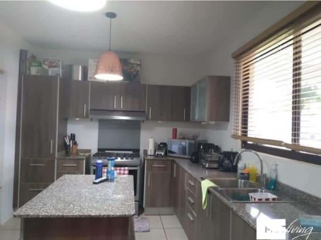 Fenced backyard lawn with swing set in private house at PH Olympus Brisas del Golf Panama