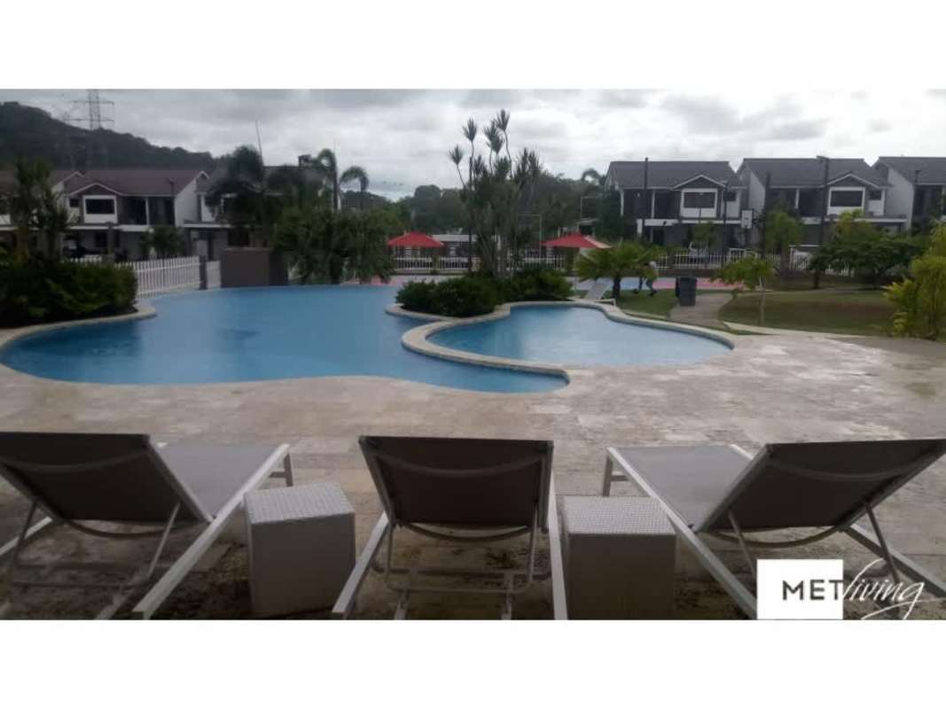 View of large swimming pool area with deck chairs in PH Olympus community Panama
