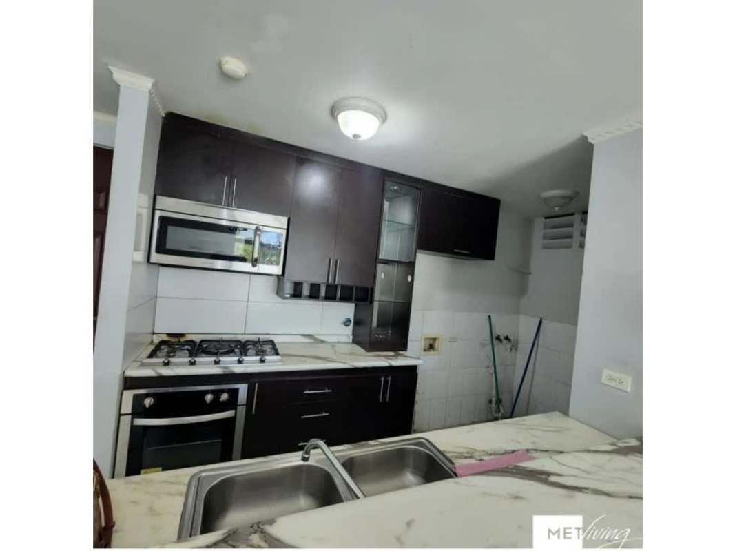 Integrated kitchen with marble-style counter and tiled backsplash in PH Los Caciques