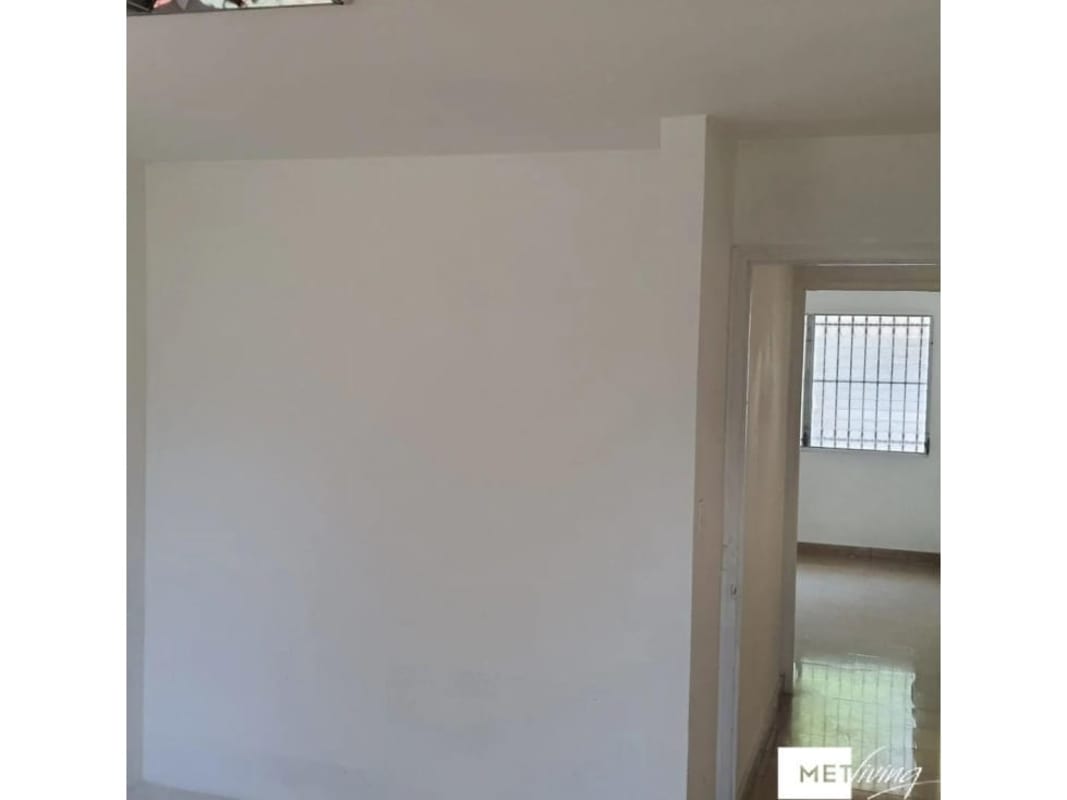 Empty remodeled room with windows, wood-look flooring ideal for reception or co-working area in San Francisco Panama