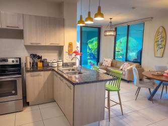 Modern kitchen with island bar granite counters in PH Ensenada Resort beachfront apartment