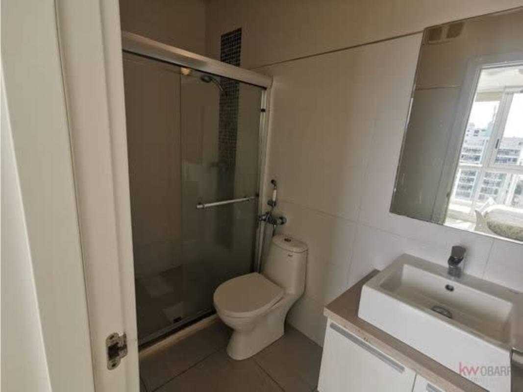 Contemporary bathroom with glass enclosed shower vanity and window city view Ocean Waves Panama