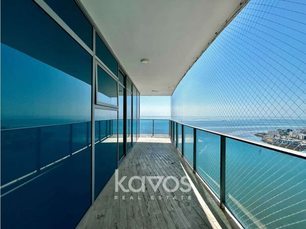 Balcony with glass railing and panoramic Pacific Ocean view at Grand Tower luxury apartment
