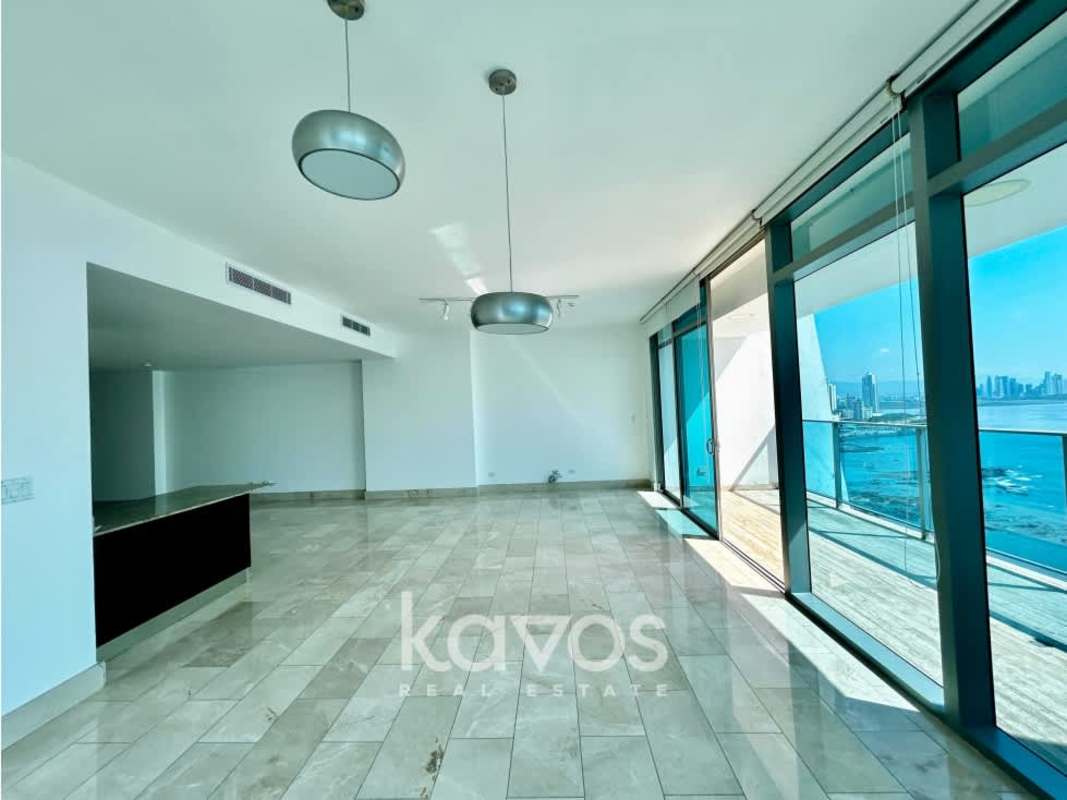 Bright spacious living dining area with floor-to-ceiling windows overlooking Pacific Ocean Punta Pacifica