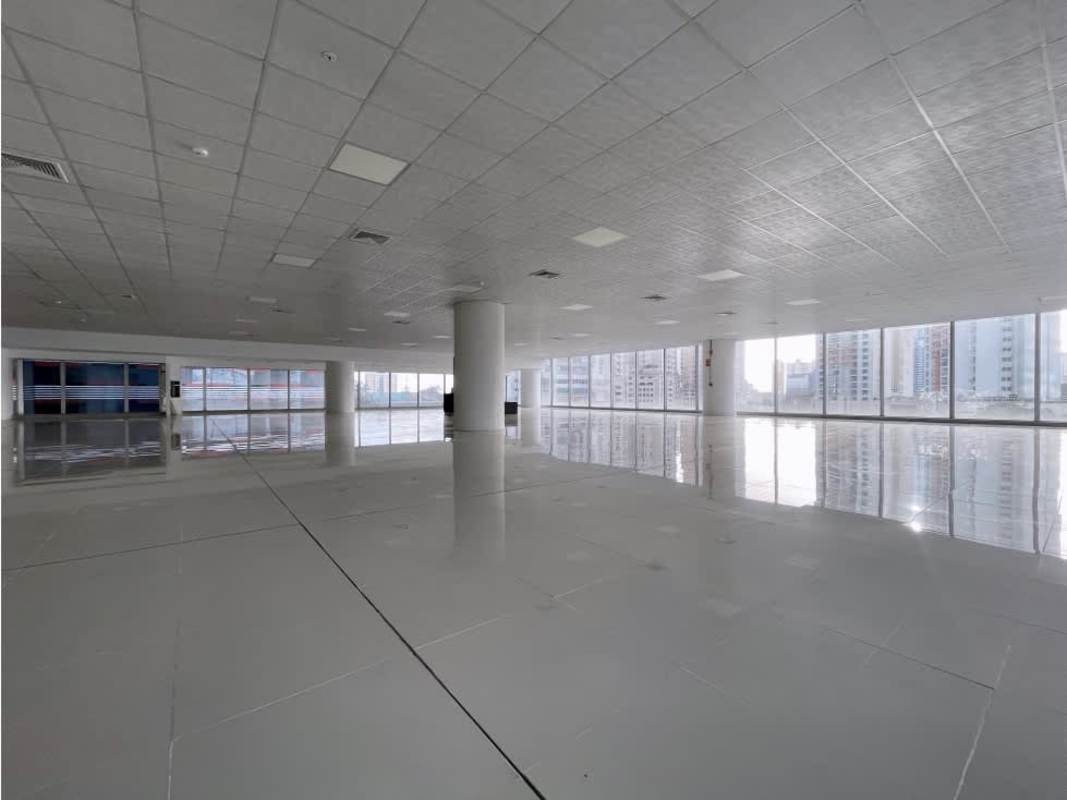 Modern commercial building lobby with glass walls, marble floors and reception area in Oceania Punta Paitilla